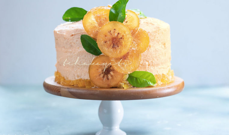 This orange cake is infused with real oranges, an orange buttercream and garnished with candied citrus slices and peel. | tchakayiti.com