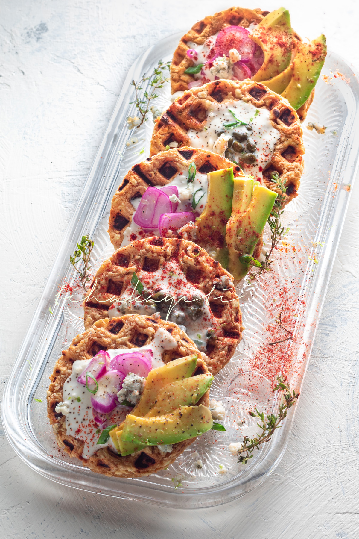 Topped with avocado, capers, gorgonzola cheese and shallots, these waffled breadfruits will elevate your brunch table. | tchakayiti.com