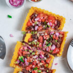 Haitian polenta pie topped with salted smoked herring, tomato salsa and pickled shallots | tchakayiti.com