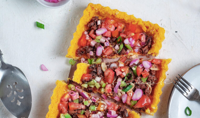 Haitian polenta pie topped with salted smoked herring, tomato salsa and pickled shallots | tchakayiti.com